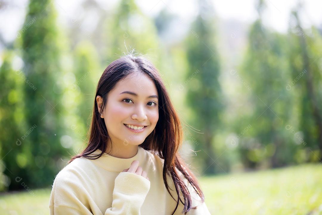 Linda mulher asiática sorrindo feliz e vestindo roupas quentes retrato de inverno e outono ao ar livre no parque