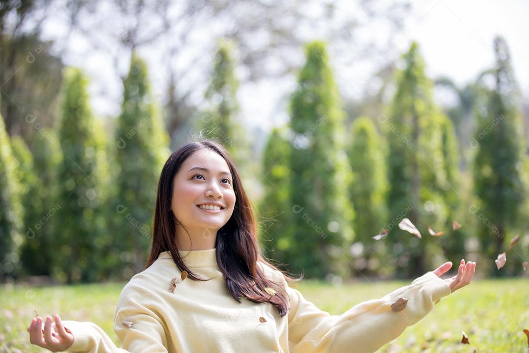 Linda mulher asiática sorrindo feliz e vestindo roupas quentes retrato de inverno e outono ao ar livre no parque
