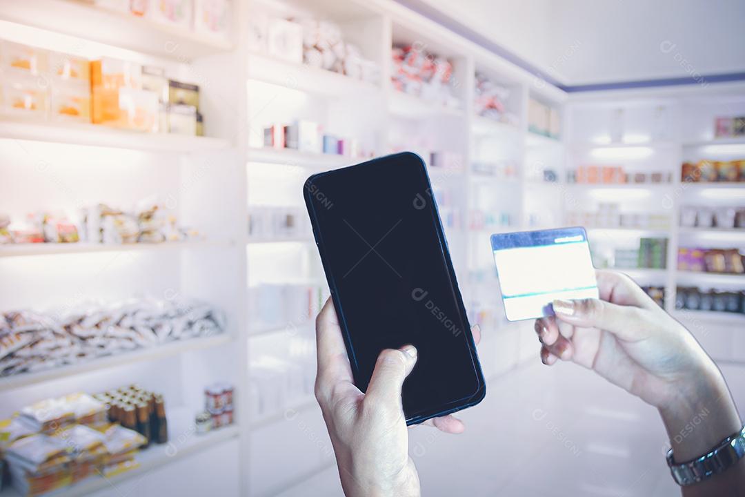 mulher asiática usando telefone inteligente e cartão de crédito compras online