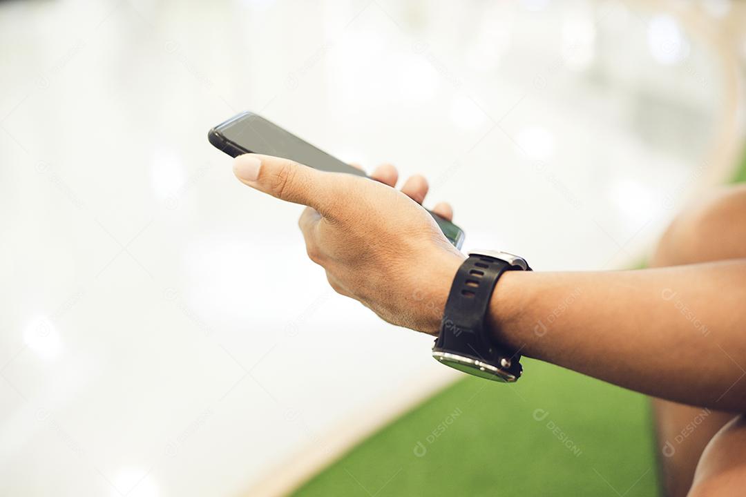 Homem asiático usando telefone para celular e mensagens de texto em seu celular