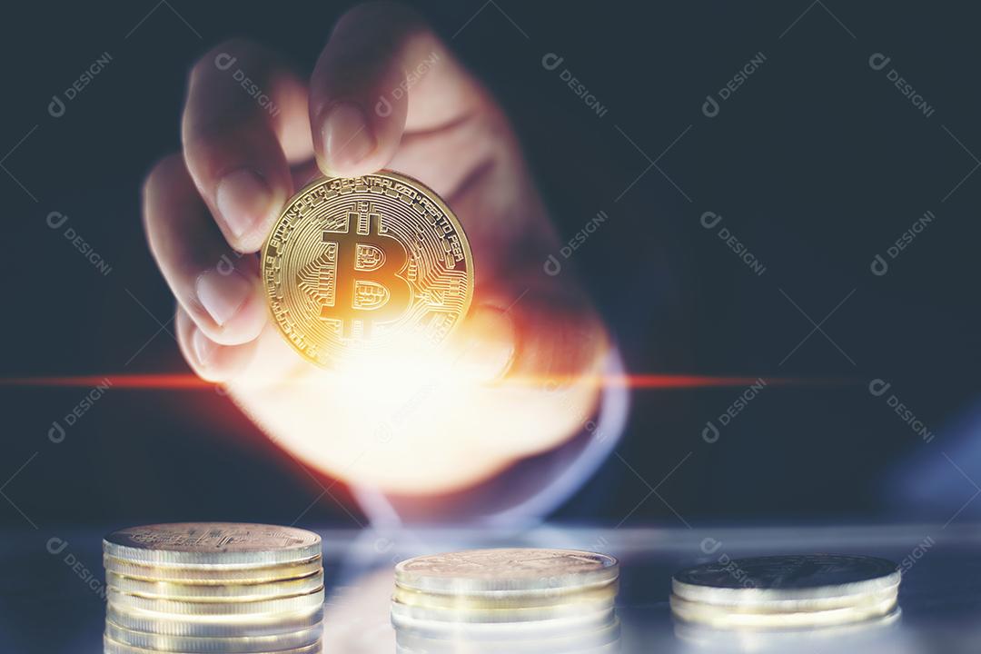 man's hand holding golden Bitcoins and new virtual money concept and financial growth concept on graph background