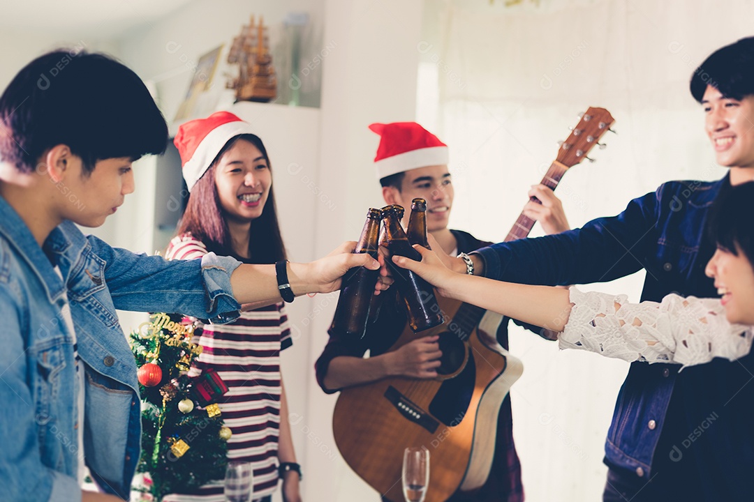 Grupo asiático de amigos festejando com cerveja alcoólica
