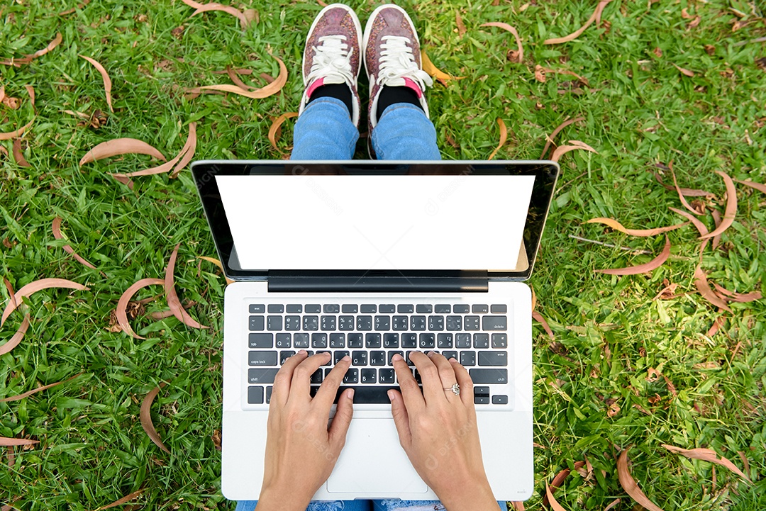 Garota de mão no teclado laptop em park city