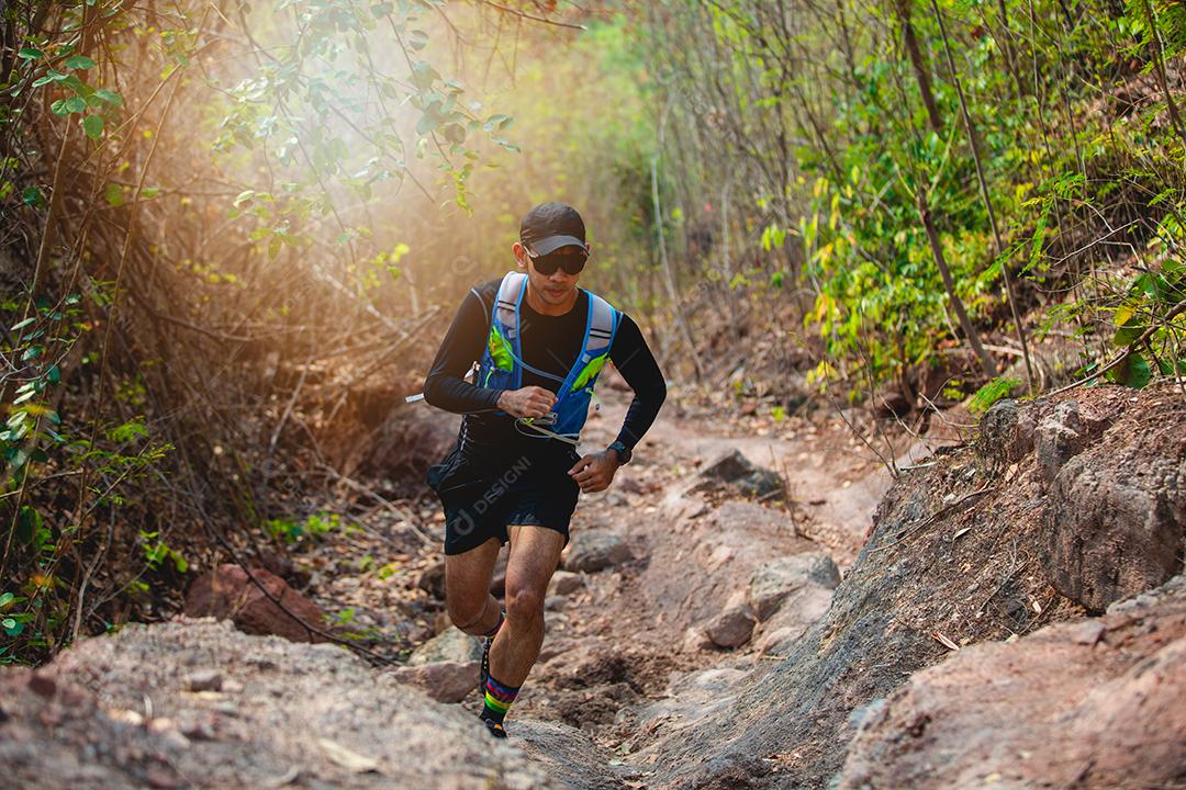 Um homem corredor de trilha. e pés de atleta usando sapatos esportivos para trilha na floresta