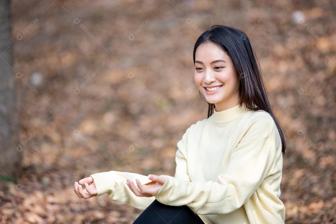 Linda mulher asiática sorrindo feliz e vestindo roupas quentes retrato de inverno e outono ao ar livre no parque