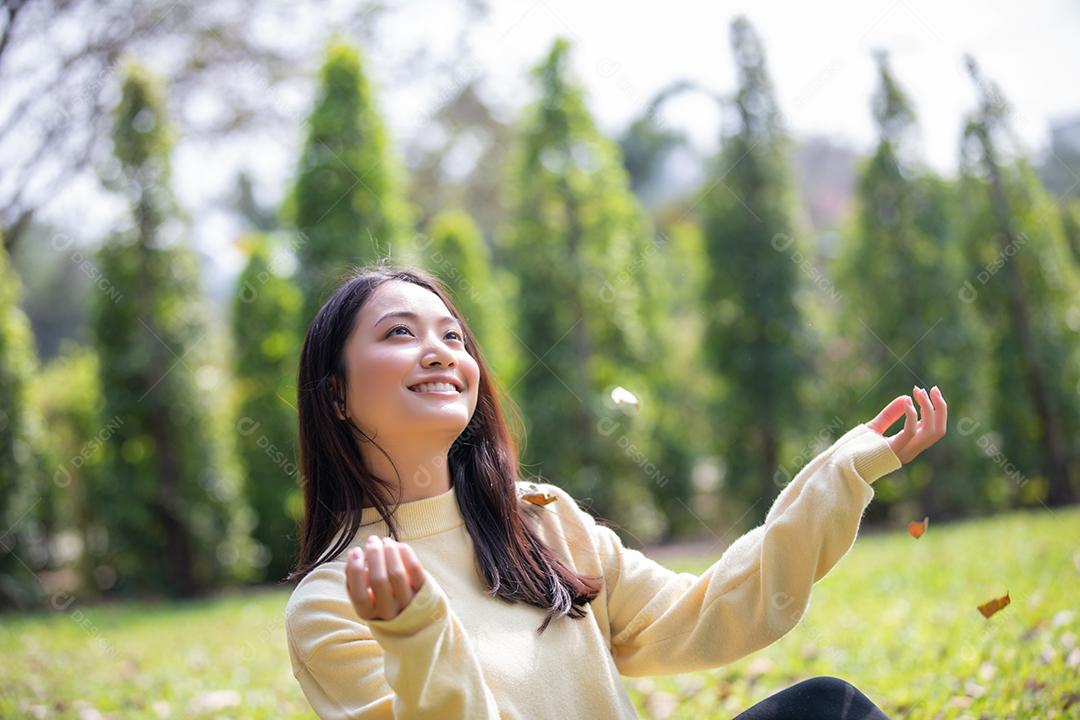 Linda mulher asiática sorrindo feliz e vestindo roupas quentes retrato de inverno e outono ao ar livre no parque