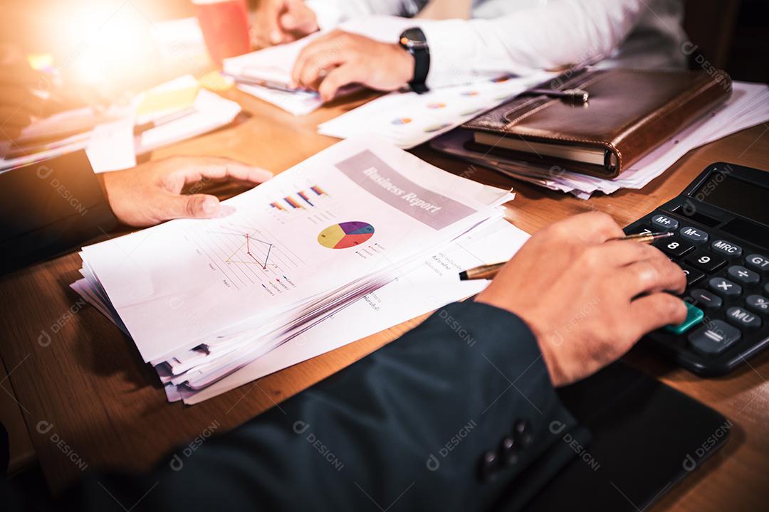 Asian businesswomen using tablet for analysis documents and chart financial diagram working in meeting