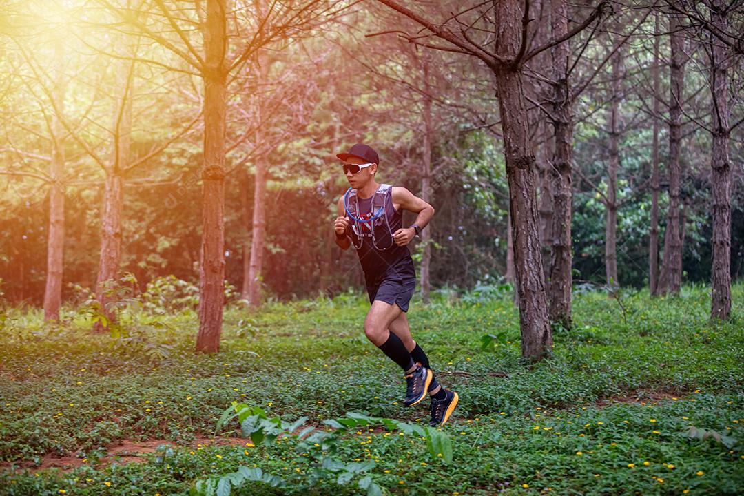 Um homem Runner of Trail e pés de atleta usando sapatos cpara trilha na floresta