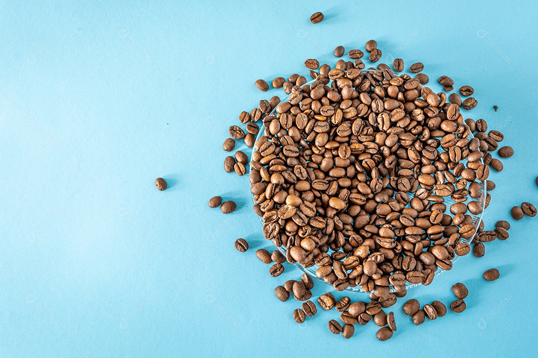 pilha de grãos de café sobre o pano de fundo azul