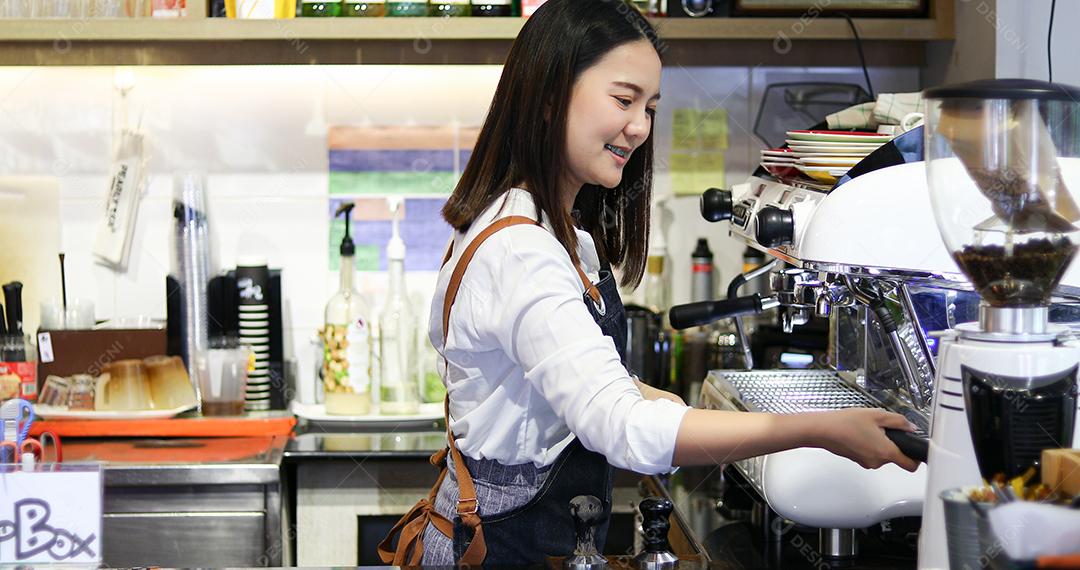 Barista atendendo cliente e mulher está pagando café com cartão de crédito na cafeteria