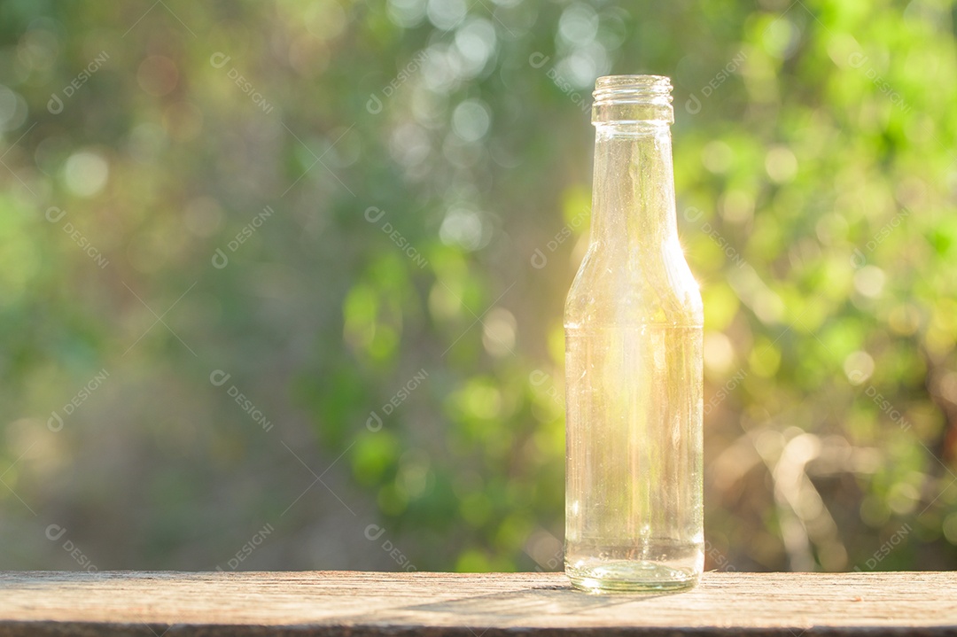 A glass bottle shining on a wooden floor