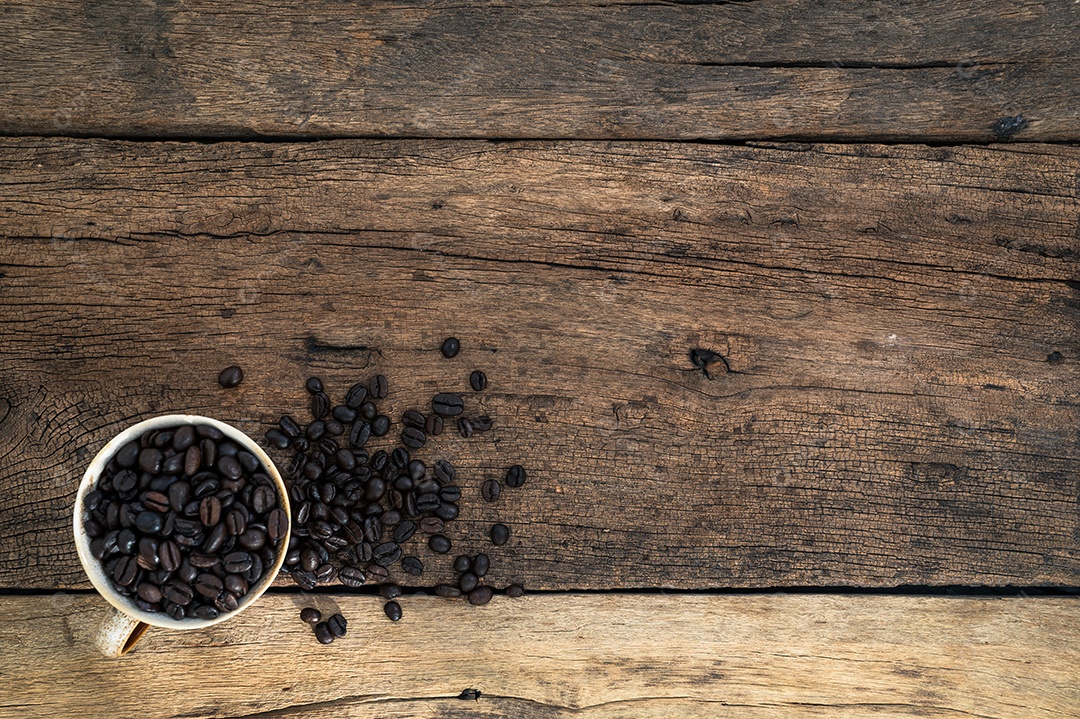 Xícara de grãos de café na vista superior da mesa