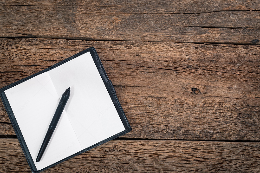 Um caderno e uma caneta na vista superior da mesa