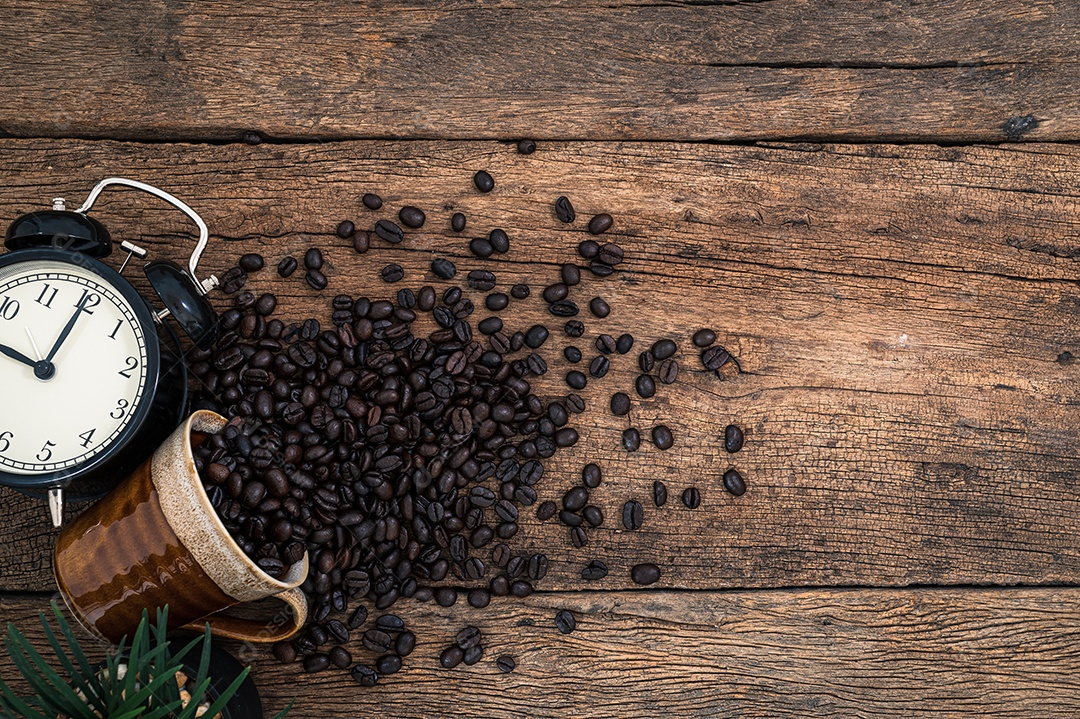 Xícara de grãos de café na vista superior da mesa