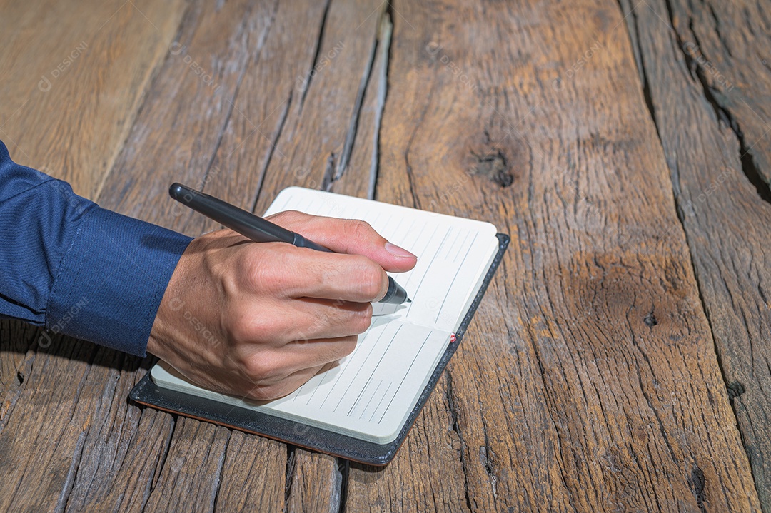 As mãos das pessoas fazem anotações em cadernos