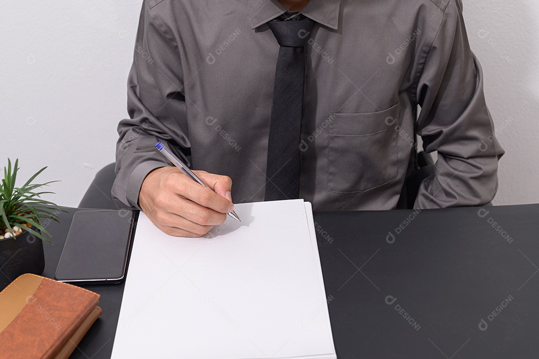 Os funcionários estão escrevendo relatórios em papel em suas mesas.