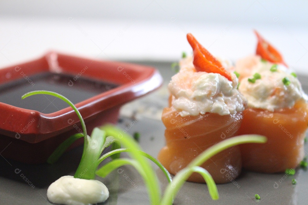 Sushi, cozinha tradicional japonesa. Vários sushi delicioso no prato decorado, fundo branco e tijela com molho