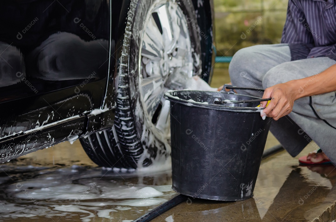 Clean car wheels with car wash foam and black water tank.