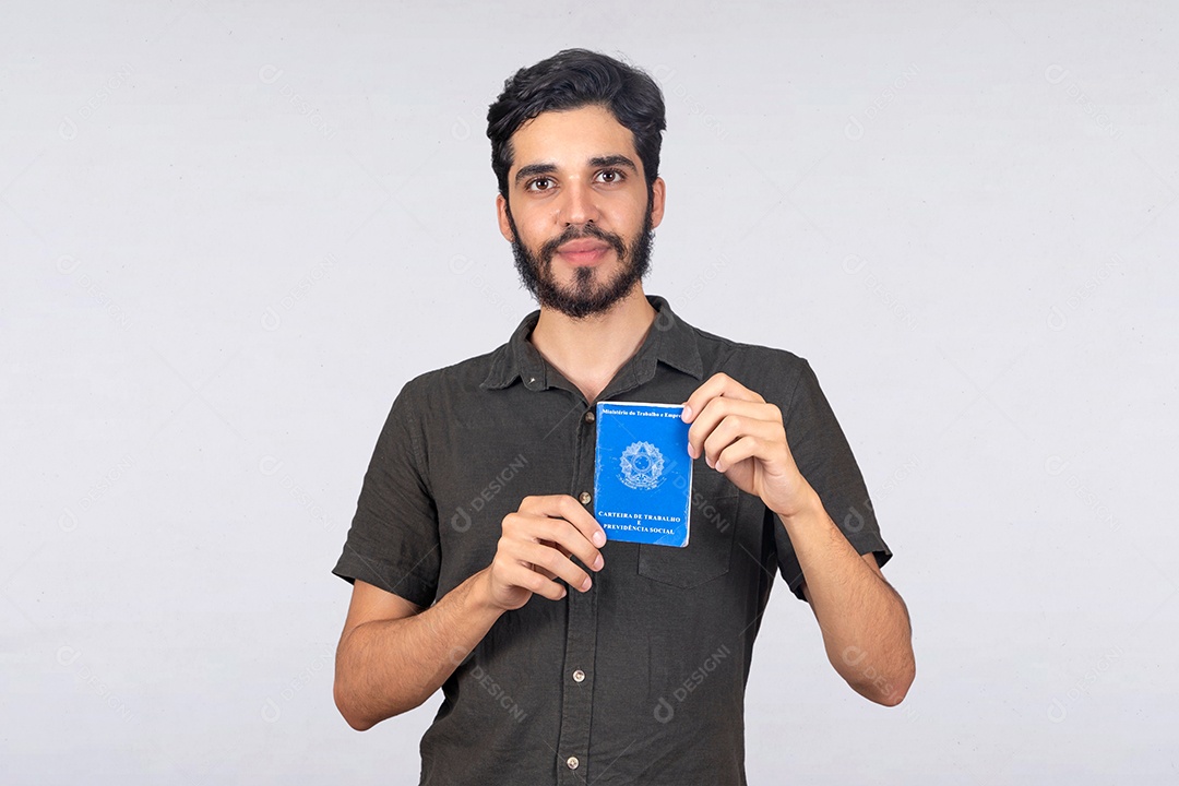 Jovem rapaz de camiseta cinza segurando sua carteira de trabalho CLT