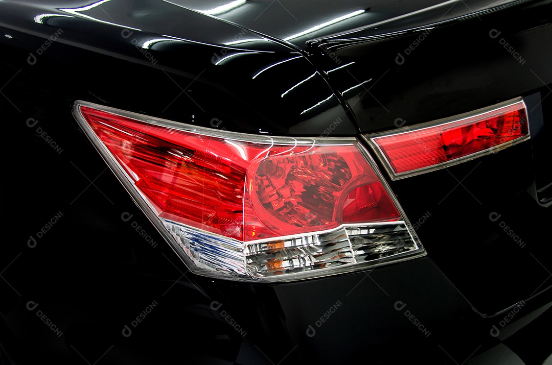 Luz traseira do carro de luxo em um fundo preto.