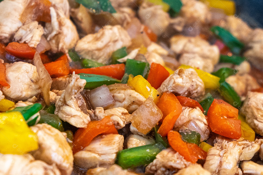 frango xadrez, comida típica chinesa servida com frango e pimentão, amendoim e arroz.