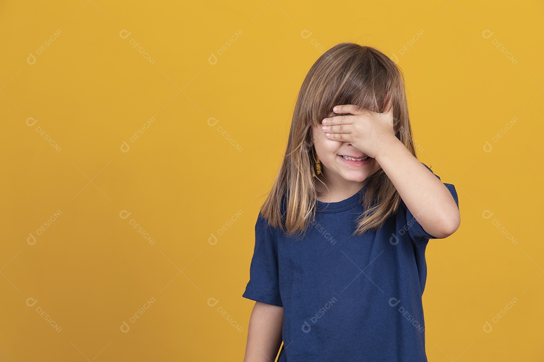 menina criança esquecida cobre o rosto com as mãos