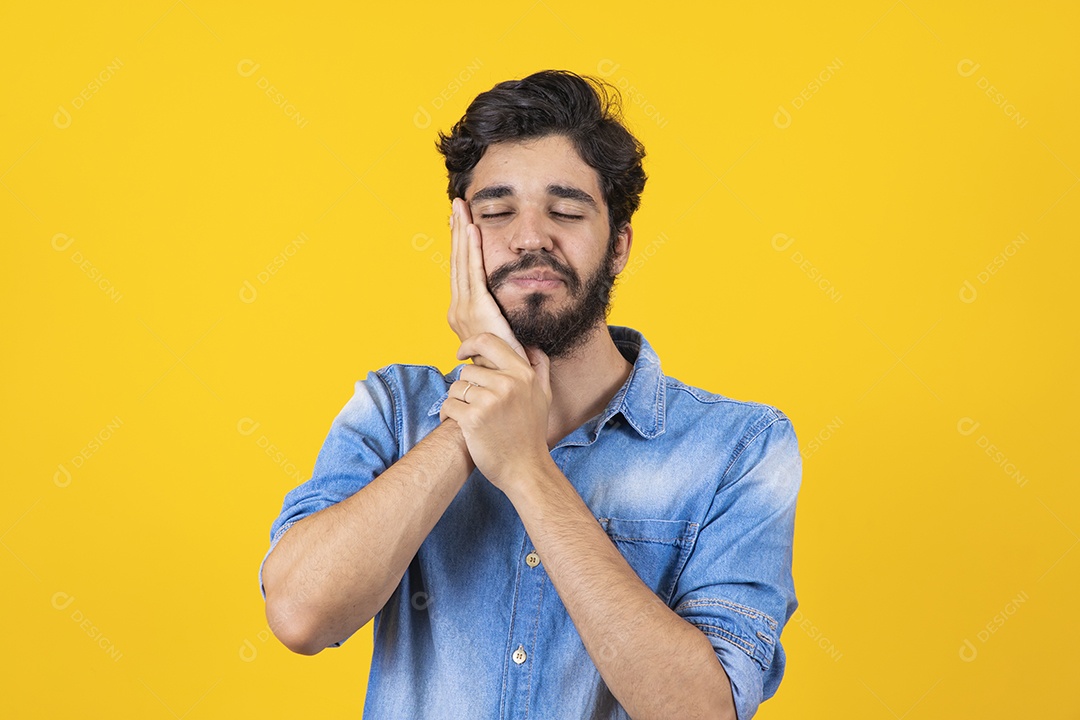 Bearded young man on yellow background