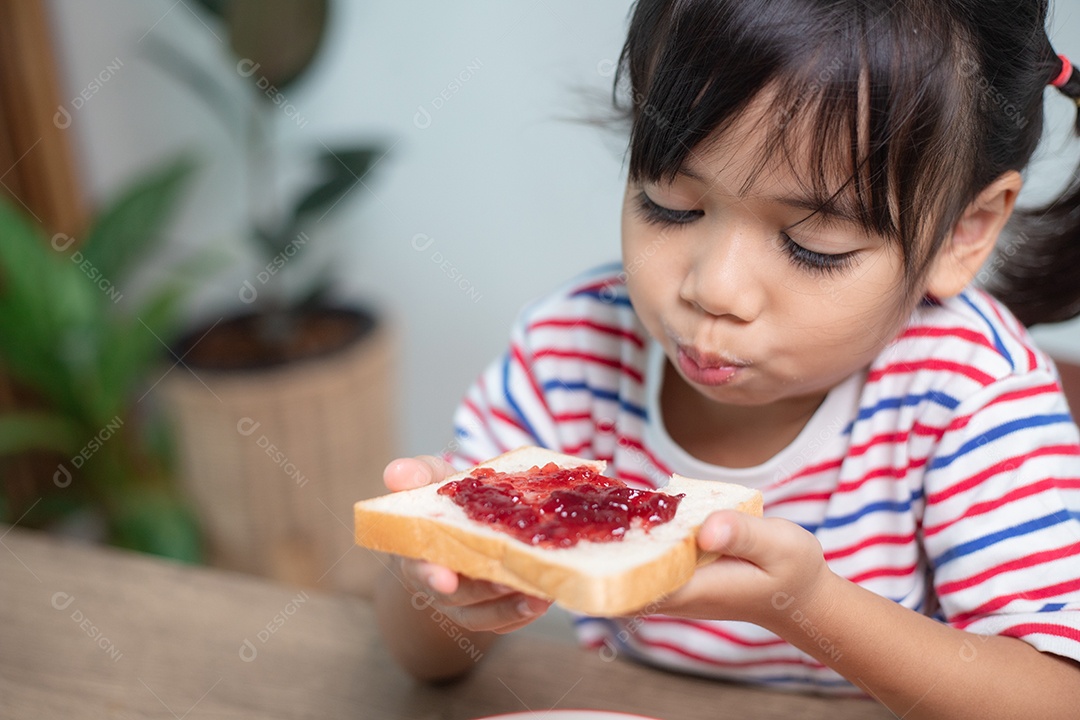 Meninas tomam café da manhã na mesa da sala de estar.