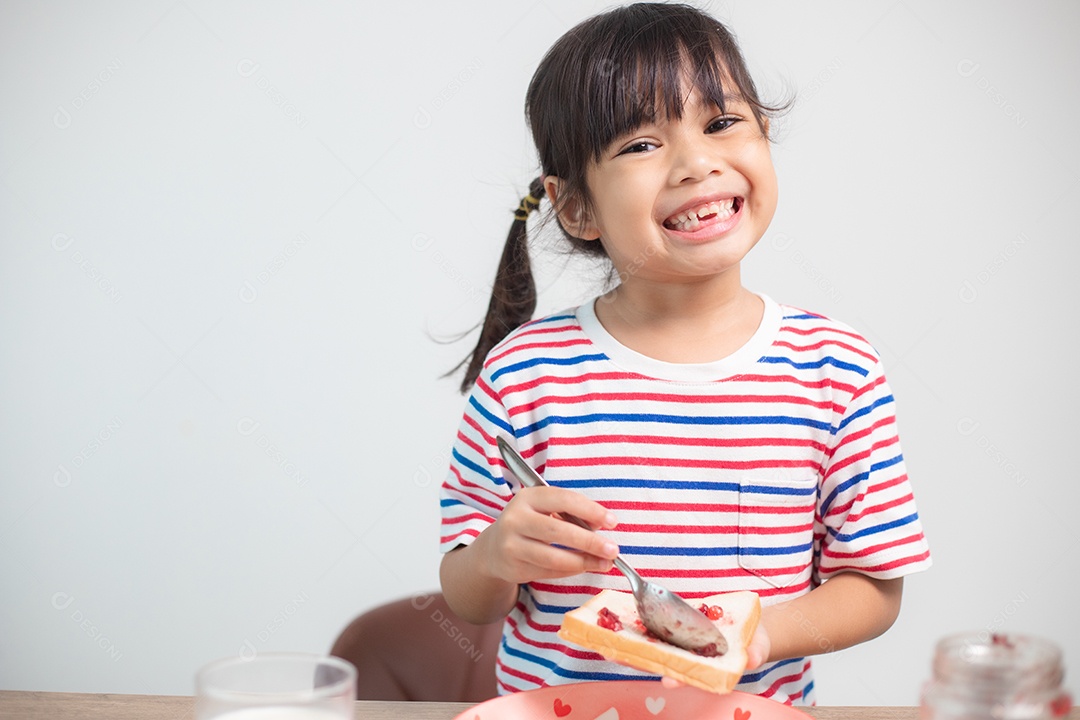 Girls have breakfast at the table in the living room.