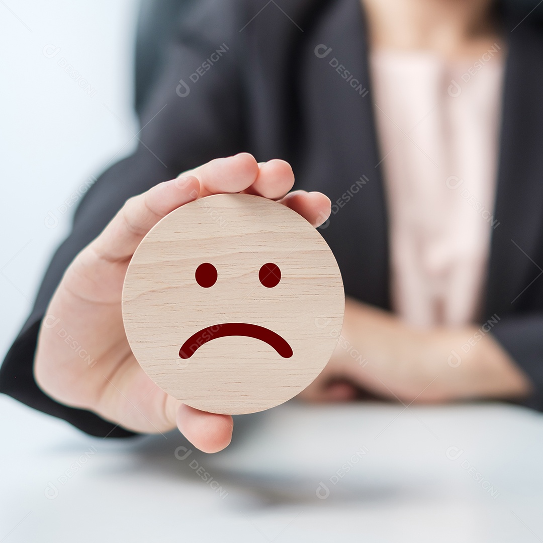 mão segurando o bloco de rosto com raiva. O cliente escolhe o Emoticon para comentários de usuários