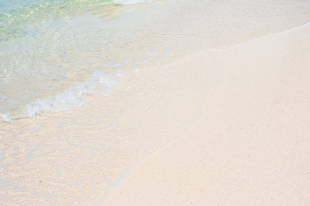 Onda suave de água do mar azul e areia branca na bela praia. Plano de fundo, papel de parede e conceito abstrato