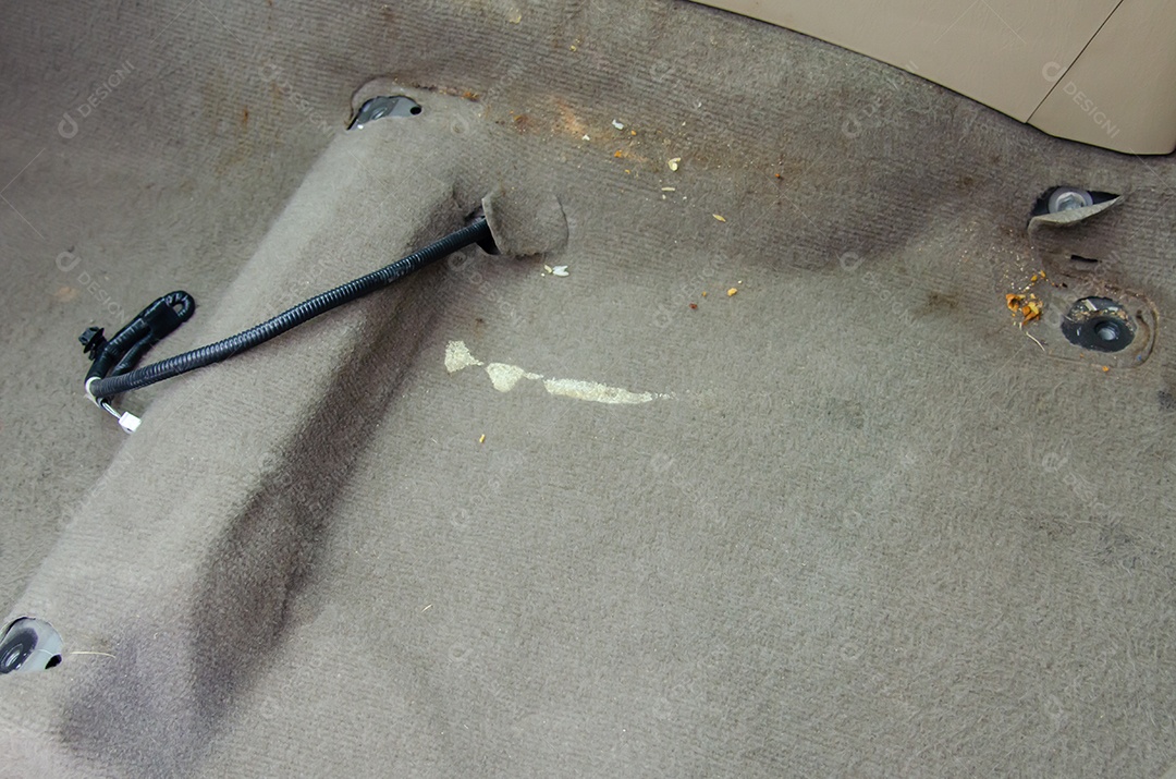 Sujeira no tapete dentro do carro.