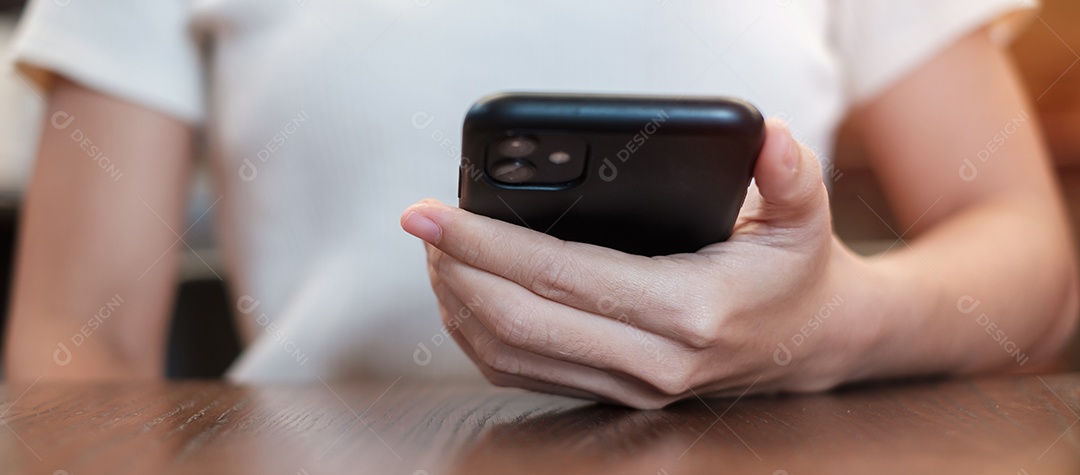 Mulher de negócios casual segurando e usando smartphone para mensagens sms, jovem digitando celular touchscreen no café ou escritório moderno. estilo de vida, tecnologia, mídia social e conceito de rede