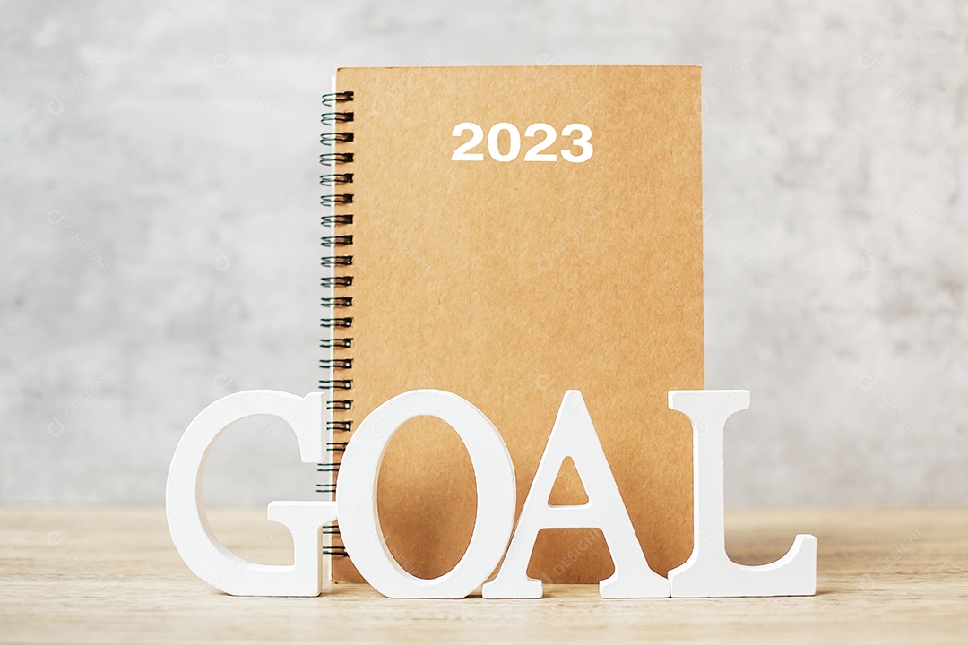 2023 happy new year with notebook and wooden number. goal, countdown, resolution, plan, action and mission concept