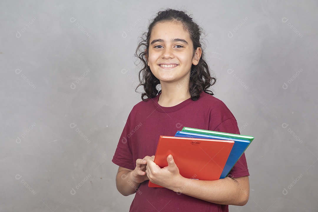 Menino estudante segurando materiais escolar
