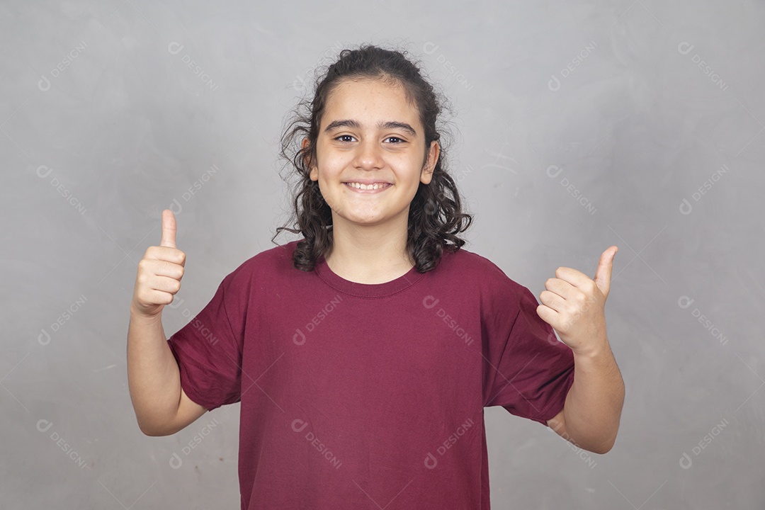Menino criança garoto sobre fundo cinza fazendo gesto positividade