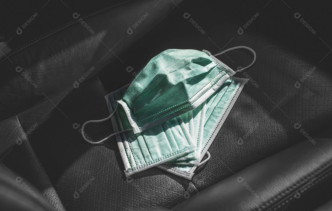 Máscara facial médica colocada no assento de couro dentro do carro, conceito de prevenção de Coronavírus (COVID-19)