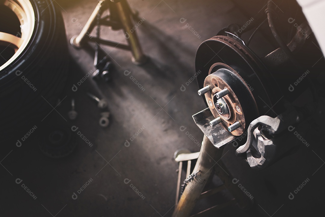 Sistema de disco de travão sem roda num suporte de macaco à espera de reparação na oficina de reparação de veículos automóveis