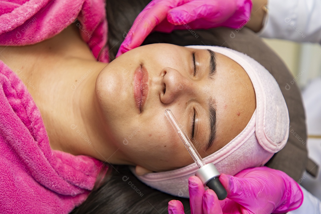 Young woman receiving cosmetic procedures by a professional in the field