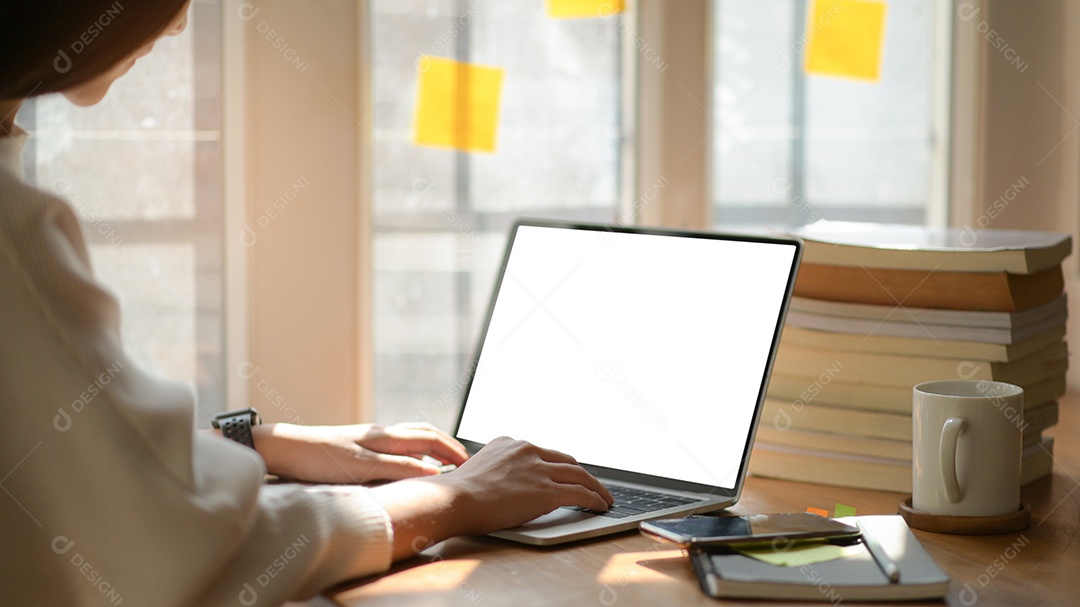 Young business woman are using blank screen laptop with office equipment in modern office.