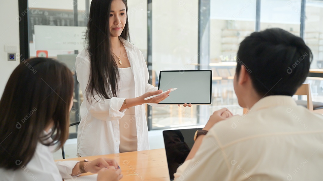 Young men and women presenting new project plan on tablet in modern office.