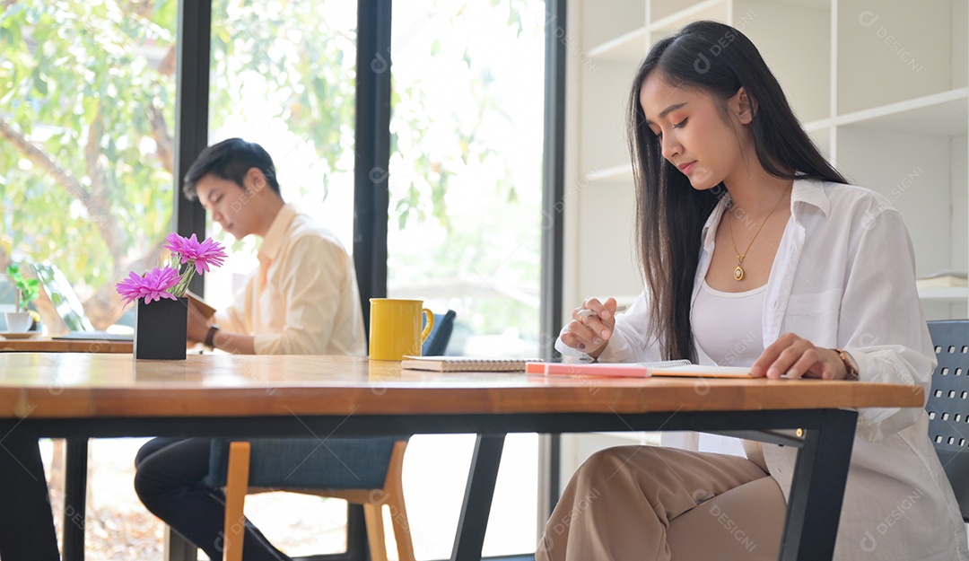 Mulher homem trabalham no Café. Eles se sentam em distanciamento social.