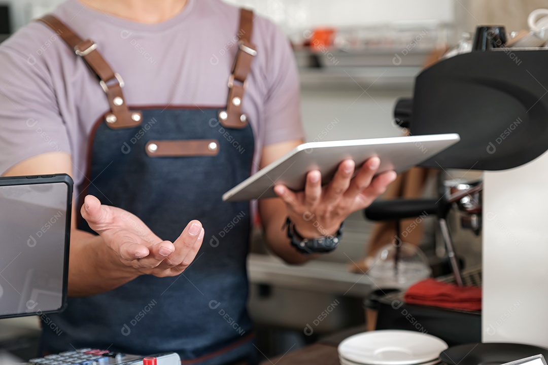 barista holding tablet in hand, recommending menu and taking orders from customers, focus on barista's hand.