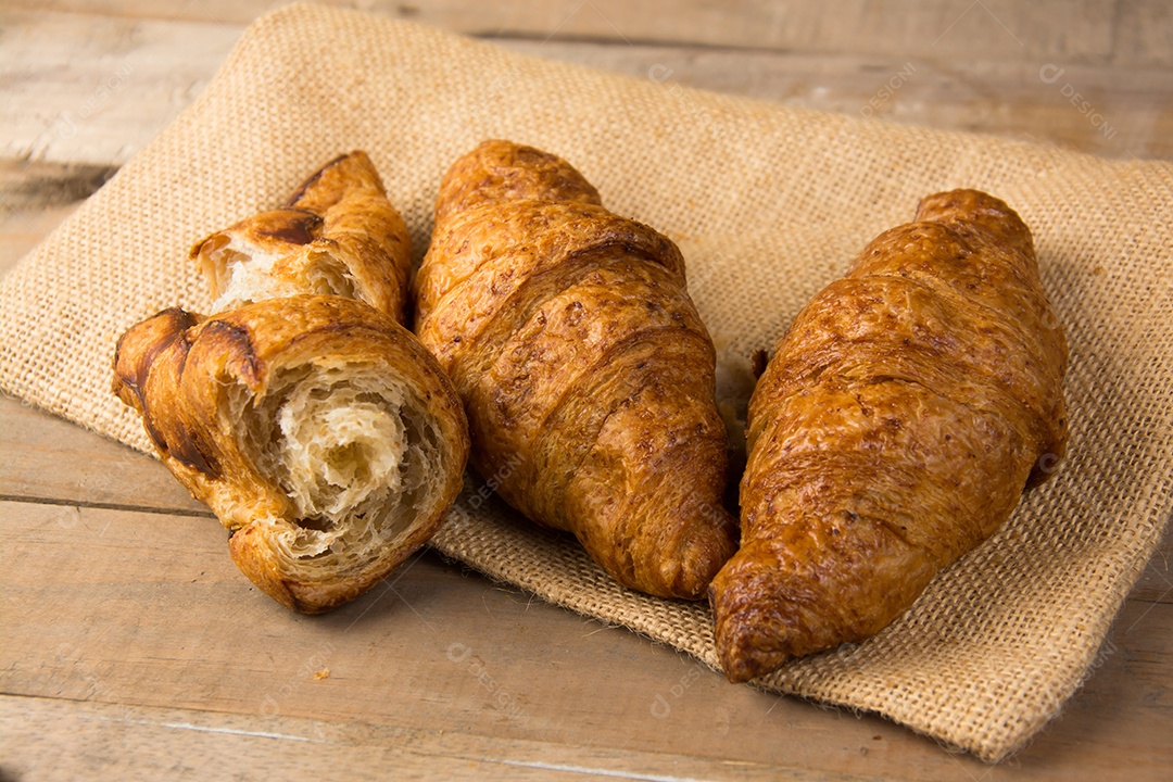 croissants recém-assados ​​em uma tábua de madeira