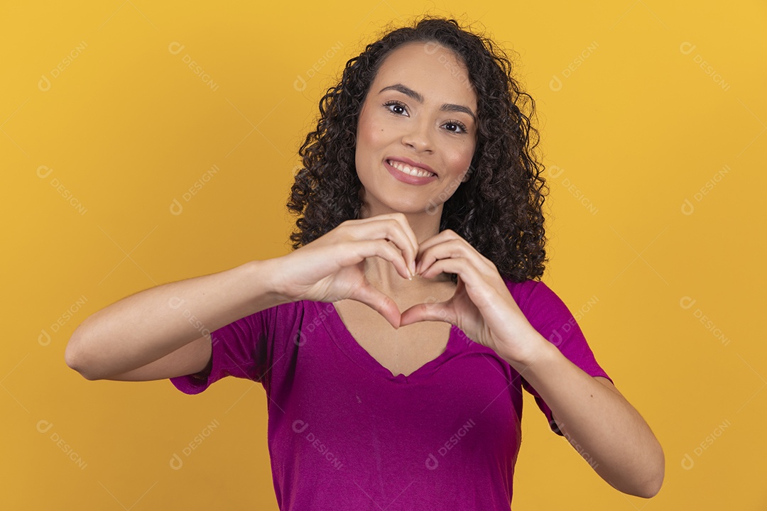 Mulher jovem cabelo cacheado sobre fundo amarelo