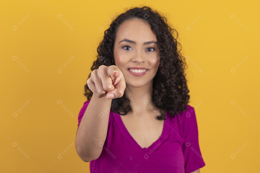 Mulher jovem cabelo cacheado sobre fundo amarelo