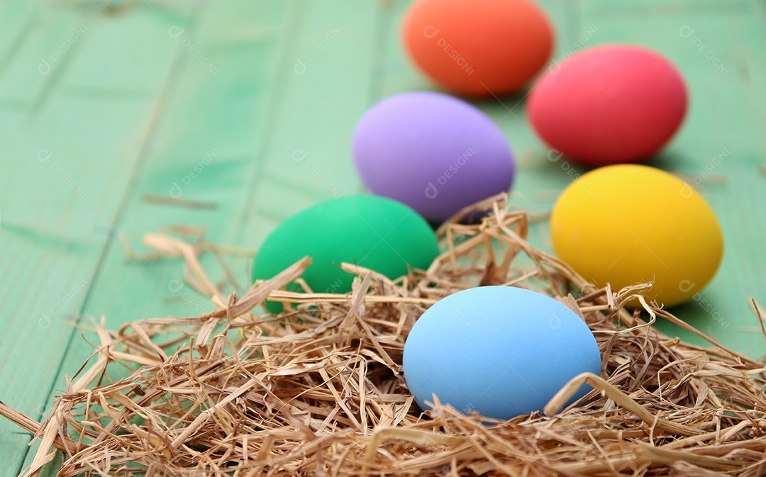 Cesta de páscoa com ovos de páscoa em fundo de madeira