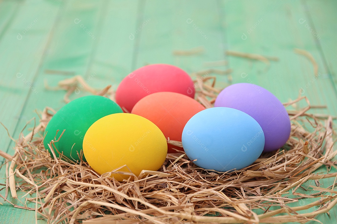 Cesta de páscoa com ovos de páscoa em fundo de madeira