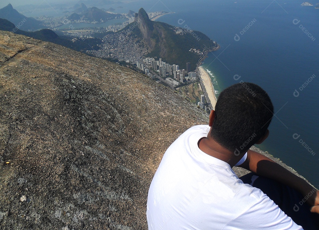 man admiring the appearance of the top of Pedra Gávea (stone da givea) in Rio de Janeiro Brazil.