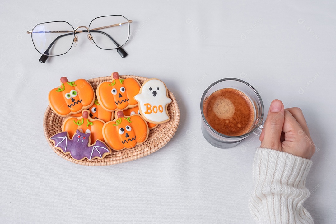 Mão de mulher segurando a xícara de café durante comer engraçado Halloween Cook